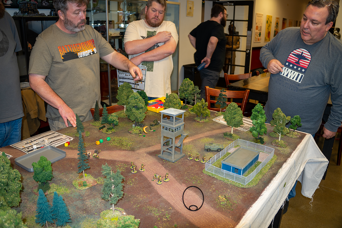 Players moving units around the OP Alpha table